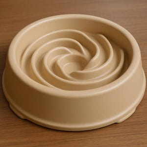 May include: A tan-colored slow feeder dog bowl. The bowl has a spiral design in the center to slow down eating. The bowl is made of a durable material and has a wide base for stability. The bowl is designed to help prevent bloat and improve digestion.