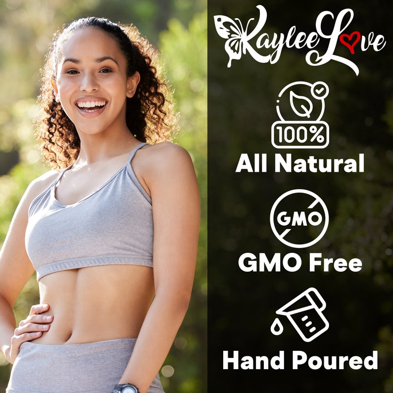 May include: A woman wearing a grey sports bra and leggings stands in front of a green background. The text "Kaylee Love" is written in white with a red heart. The text "100% All Natural" is written in white. A white circle with a red slash through it and the text "GMO" is written in white. The text "GMO Free" is written in white. A white outline of a measuring cup with a drop of liquid and the text "Hand Poured" is written in white.