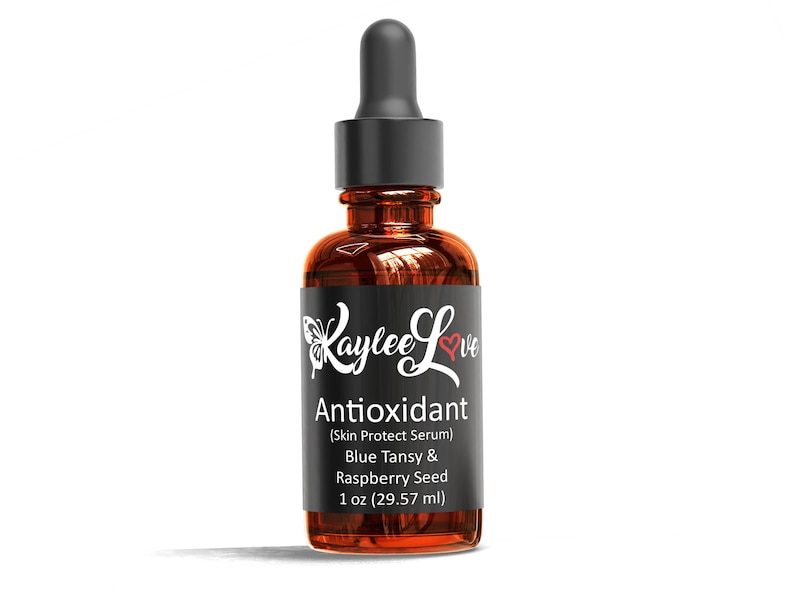 May include: A brown glass bottle with a black dropper top and a black label. The label says "Laylee Love Antioxidant (Skin Protect Serum) Blue Tansy & Raspberry Seed 1 oz (29.57 ml)"