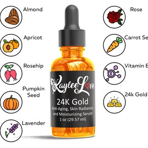 May include: A clear glass bottle with a black cap and a gold label that reads "Kaylee Love 24K Gold Anti-Aging, Skin Radiance, and Moisturizing Serum 1 oz (29.57 ml)". The bottle is surrounded by icons representing ingredients including almond, rose, apricot, carrot seed, rosehip, pumpkin seed, lavender, vitamin E, and 24k gold flakes.