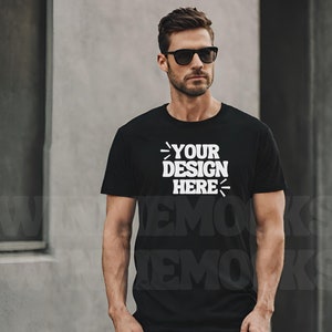 May include: A black t-shirt with the text "YOUR DESIGN HERE" printed in white on the front.