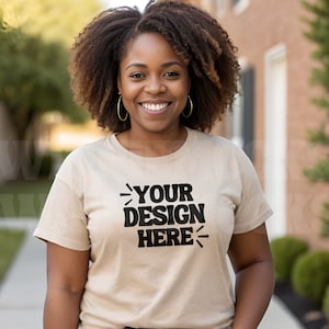 May include: A person wearing a beige t-shirt with the text "YOUR DESIGN HERE" printed in black.