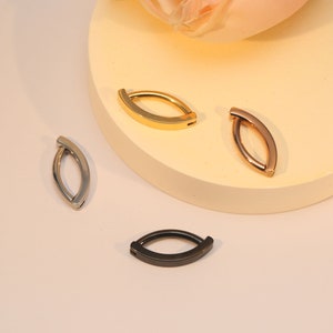 May include: Three hoop earrings in different finishes: gold, rose gold, and silver. The hoops are all the same size and shape, and they are all made of metal.