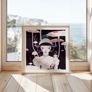 May include: A framed art print depicting a surreal illustration of a person amidst large, stylised mushrooms. The artwork has a dark background with pink and white mushroom caps, creating a serene, dreamlike atmosphere. The frame is a light wood colour.