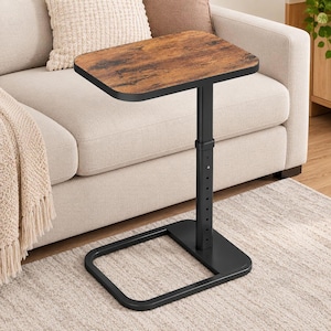 May include: A rectangular side table with a brown wood-grain finish top and a black metal frame. The table features a single vertical support post with multiple adjustment holes for height, connected to a flat, square-shaped base frame.