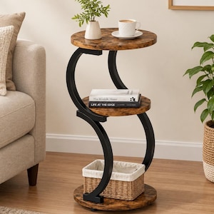 May include: A three-tier side table with a dark brown wood grain finish and a black metal frame. The table features a curved, S-shaped design with three circular shelves. A woven basket sits on the bottom shelf, while books are on the middle.