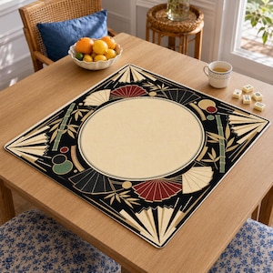 May include: A square game mat featuring a large central beige circle surrounded by a black border decorated with stylized folding fans in red, cream, and black, along with green bamboo stalks and small circular accents in red, green, and gold.