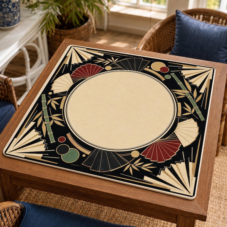 May include: A square game mat featuring a large central cream-colored circle surrounded by a black border. The design includes stylized folding fans in cream, red, and black, along with green bamboo stalks and small solid circles in red and green.