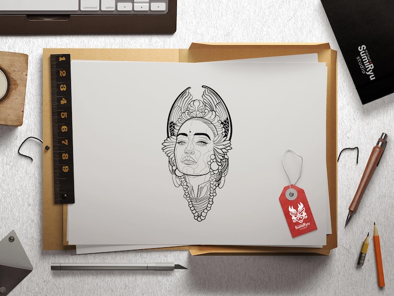 May include: A black and white line drawing of a woman's face with intricate floral designs around her head and neck. The drawing is on a white sheet of paper.