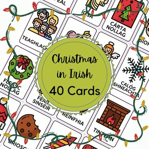 May include: A set of 40 illustrated cards featuring Christmas-themed images and Irish words. The cards are white with purple borders and feature colorful illustrations. The cards are arranged in a grid pattern and are surrounded by a green garland with red lights.