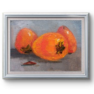 May include: A framed oil painting of three orange persimmons on a gray background. The persimmons are arranged in a cluster, with the largest one in the center.