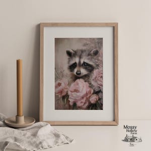 May include: A framed art print featuring a raccoon surrounded by pink flowers. The raccoon has gray and black fur with a sweet expression. The artwork is in a wooden frame and is a soft, romantic style.
