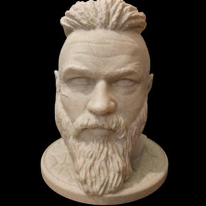 May include: A light beige bust of a man with a full beard and a distinctive hairstyle. The sculpture shows detailed facial features and a scar on the cheek. The bust is mounted on a circular base.