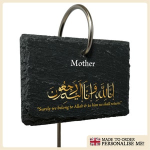 May include: Black slate plaque with a gold inscription that reads "Mother" and an Arabic inscription that reads "Surely we belong to Allah & to him we shall return." The plaque is attached to a metal ring.
