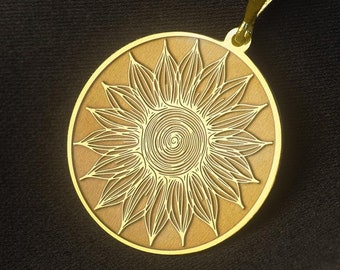May include: A gold chain necklace with a round pendant featuring a detailed sunflower design.