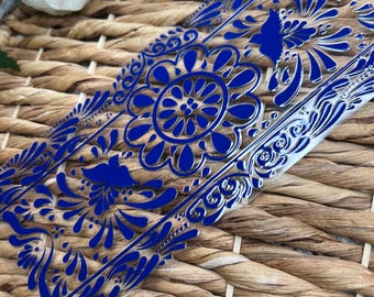 May include: A clear phone case with a blue floral design. The design features intricate swirls and a large circular pattern in the center.