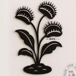 May include: Black silhouette of a Venus flytrap plant with three traps, leaves, and a stem. The plant is rooted in the ground. The image is labelled "By okimi..." and "FILES FOR CRAFTS okimi DESIGNS".