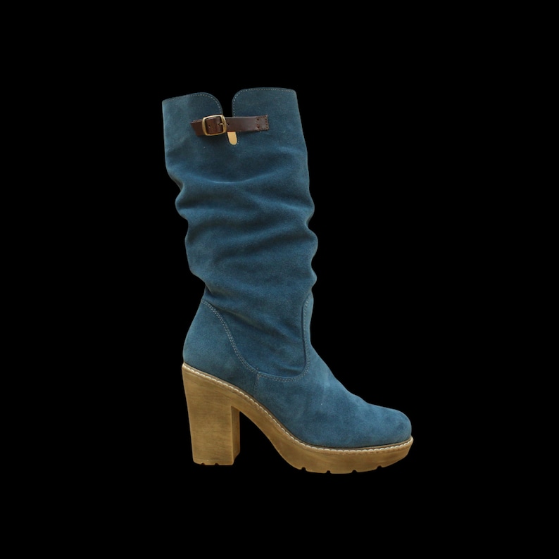 Petrol blue suede leather high heel women boots for winter season and work occasion. Crafted of leather insole and soft pad. Anti slip rubber sole. Minimalist boots for everyday use.