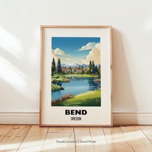 May include: Framed art print featuring a scenic watercolor illustration of Bend, Oregon. The artwork depicts a lake, trees, buildings, and mountains under a blue sky with clouds. The text "BEND OREGON" is at the bottom.
