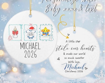 Op de afbeelding: Twee ronde witte keramische ornamenten met gouden ophangkoorden. De eerste toont een babyfles, een rompertje met kerstmuts en een ster, met de tekst Michael 2026. De tweede toont de tekst A little star stole our hearts & made our world so much sweeter With love, Michael Christmas 2026.