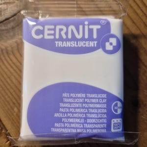 May include: A package of translucent polymer clay, labeled "CERNIT TRANSLUCENT". The package includes instructions for baking the clay at 130 degrees Celsius or 265 degrees Fahrenheit for 30 minutes.
