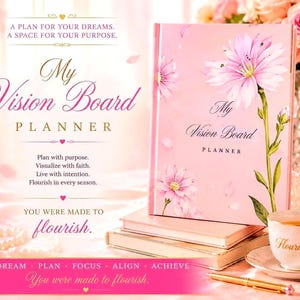 May include: A pink hardback vision board planner featuring a floral illustration on the cover with the text My Vision Board PLANNER. The planner rests on a stack of books next to a white teacup with the word Flourish and a gold pen.