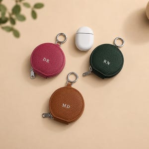 Berry pink, green or brown circular zipper pouch.