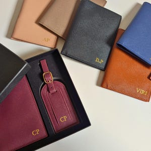 Maroon travel set in a gift box with the blue, brown, black, khaki and nude passport covers displaying the color options.