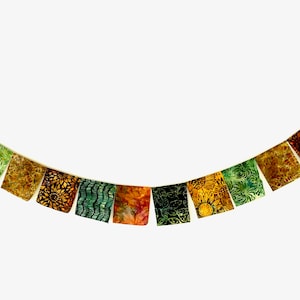 May include: A string of colorful fabric flags with green, yellow, and orange patterns. The flags are strung together with a white cord and hang in a curved shape.