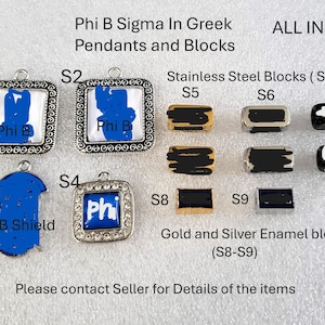 May include: A collection of Phi B Sigma pendants and blocks labeled S1 through S9. The items include square silver-toned pendants with decorative borders, a shield-shaped pendant, and rectangular metal blocks in gold, silver, and black enamel finishes.