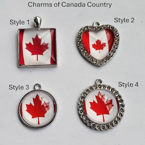 May include: Four silver-toned metal charms featuring the Canadian flag with a red maple leaf on a white background. The text Charms of Canada Country is at the top. Style 1 is square, Style 2 is heart-shaped with rhinestones, Style 3 is round, and Style 4 is round with rhinestones.