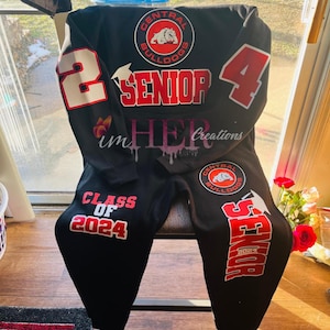May include: Black sweatpants with red and white text that says "Class of 2024" and "Senior 2024". The sweatpants also have a red and white logo that says "Central Bulldogs".