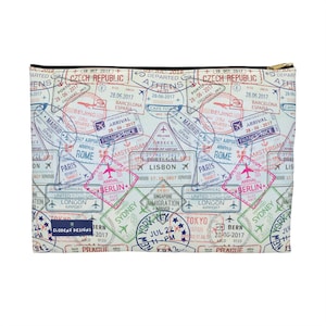 May include: A rectangular travel-themed zippered pouch featuring a collage of colorful passport stamps from various cities like Paris, Berlin, and Tokyo. The pouch has a black zipper and the text "ELODENZ DESIGNS".