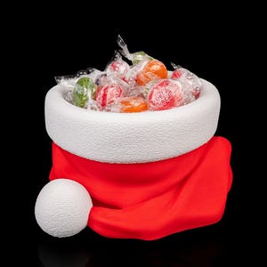 May include: A festive Santa hat filled with wrapped hard candies. The hat is red with a white brim and a white pom-pom. The candies are various colors, including red, orange, green, and clear.