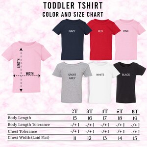 May include: A toddler t-shirt colour and size chart. The chart shows six t-shirts in navy, red, pink, sport grey, white, and black. Measurements for body length and chest width are provided in inches, with size tolerances.
