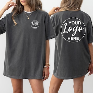 May include: A charcoal gray oversized t-shirt with a white circle on the front and back that says "YOUR LOGO HERE".