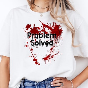 May include: White t-shirt with red blood splatter and the text "Problem Solved" in black.