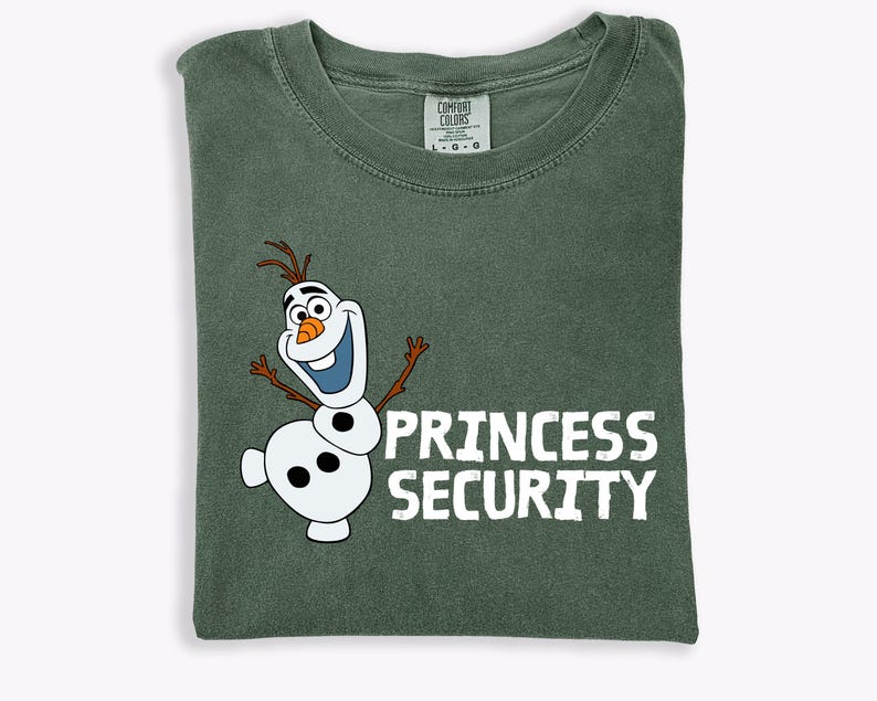 May include: A green Comfort Colors t-shirt featuring a cartoon image of Olaf the snowman with the words "PRINCESS SECURITY" in white block letters. The shirt is folded and has a tag at the neckline.
