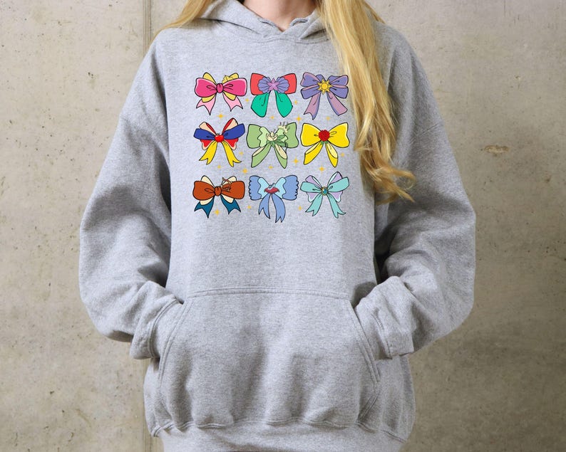 May include: A gray hoodie with a colorful bow design. The bows are in various colors, including pink, blue, yellow, and green.