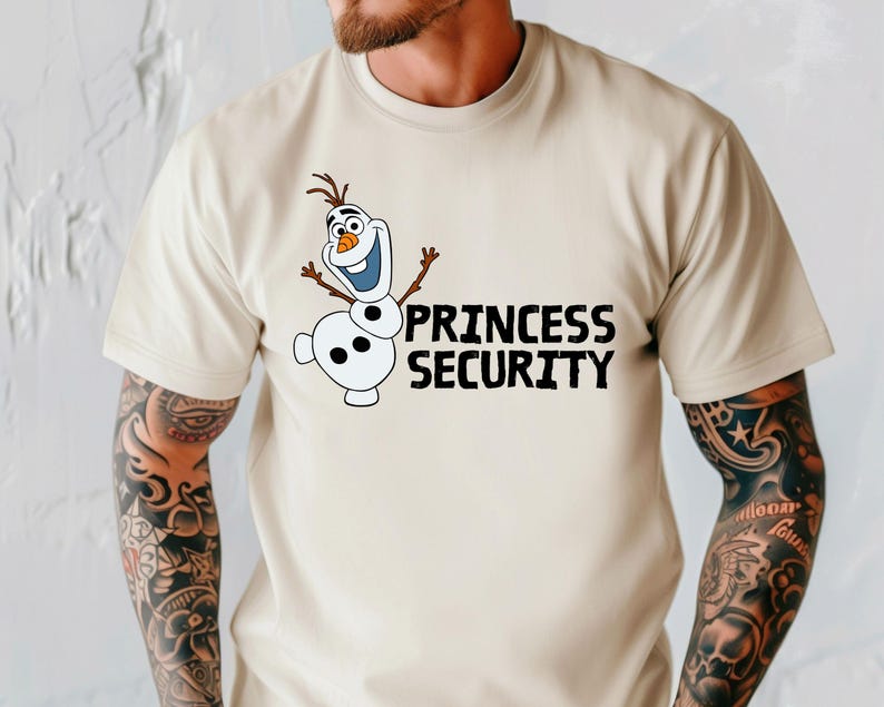 May include: Beige t-shirt featuring a cartoon image of Olaf from Frozen, with the text "PRINCESS SECURITY" in black. Olaf is white with a carrot nose, twig arms, and a brown hair. The shirt has short sleeves.