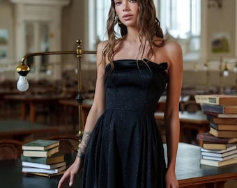 Elegant black corset dress with back bow detail in jacquard cotton and satin insert, classic midi length formal evening style