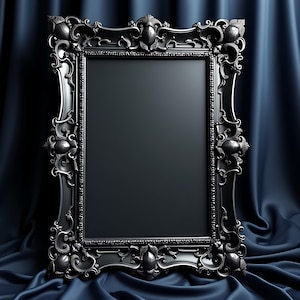 May include: A black ornate picture frame with intricate detailing. The frame has a rectangular opening and is made of a dark, possibly metallic material. The background is a dark blue fabric, creating a dramatic contrast.
