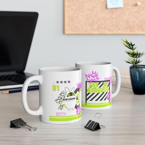 May include: Two white ceramic mugs with a pink and green graphic design. One mug features a cartoon character with the text "Now Loading" and the other mug features a goal with the text "The Bangboo".