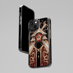May include: A clear phone case with a black background and a colourful design. The design features a large eye with a sun inside, surrounded by snakes and other geometric shapes. The case is compatible with an iPhone 12 Pro Max.