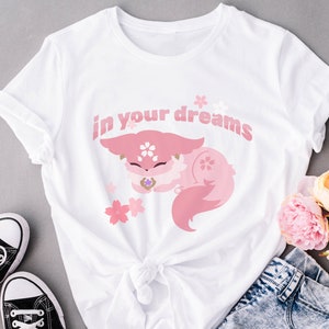 May include: White t-shirt with a pink cartoon fox sleeping with the text "in your dreams" printed on it.
