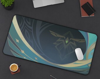 May include: A teal and gold mousepad with a stylized design featuring a green gem and a swirling pattern. The mousepad is on a dark gray surface.