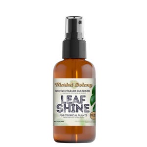 May include: A brown glass bottle with a black spray nozzle and a label that reads "Market Botany Gentle Foliage Cleanser Leaf Shine For Tropical Plants Para Plantas Tropicales Oil Free Formula Net 4 fl oz (118 ml)"
