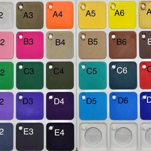 May include: A color chart featuring 36 square color swatches in various shades. The swatches are arranged in a grid and labeled with letters and numbers. Colors include white, pink, green, blue, and brown.