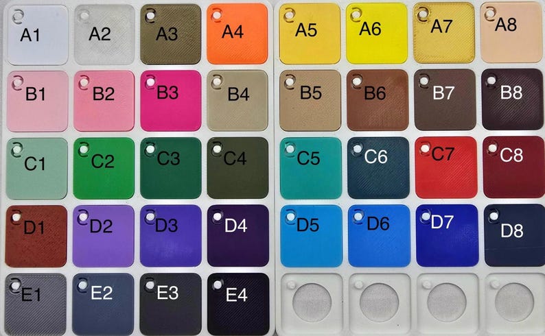 May include: A color chart featuring 36 square color swatches in various shades. The swatches are arranged in a grid and labeled with letters and numbers. Colors include white, pink, green, blue, and brown.