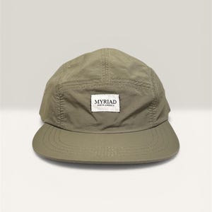 May include: A set of three ceramic mugs with a speckled, matte finish in cream, light grey, and dark grey. Each mug has a minimalist design, ideal for coffee or tea.